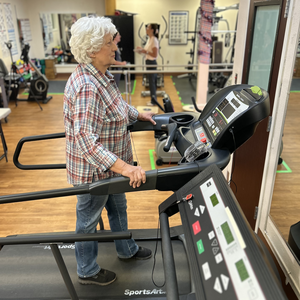 Female walking on a treadmill in outvpatient services.